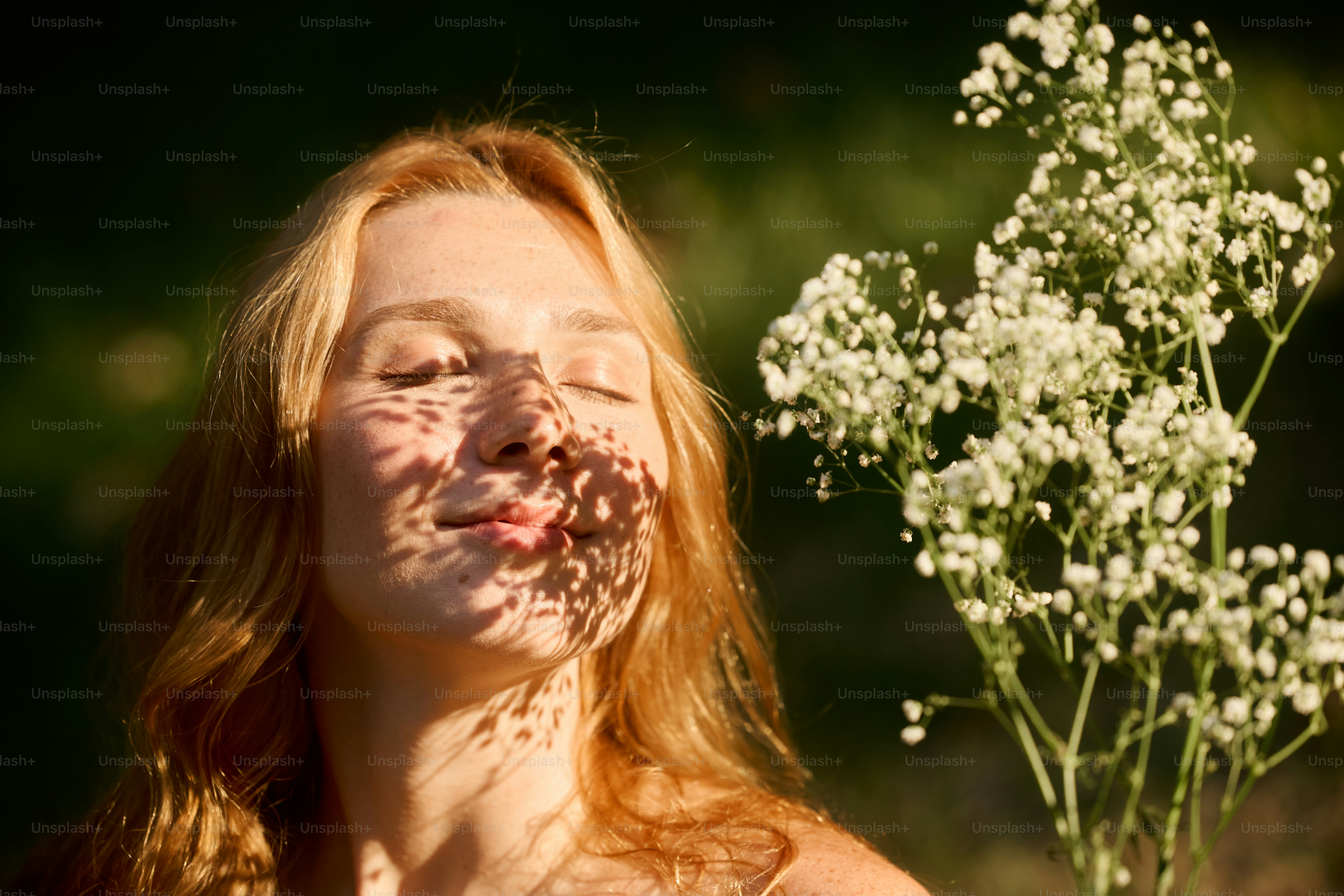 a woman with her eyes closed and a bouquet of flowers in front of her