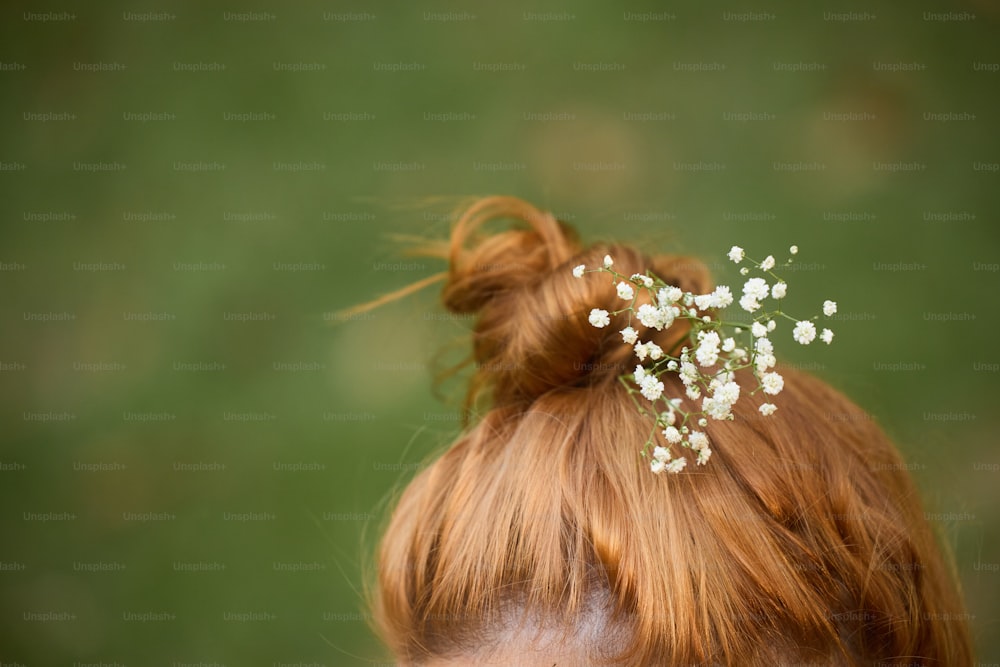 a close up of a woman with a flower in her hair