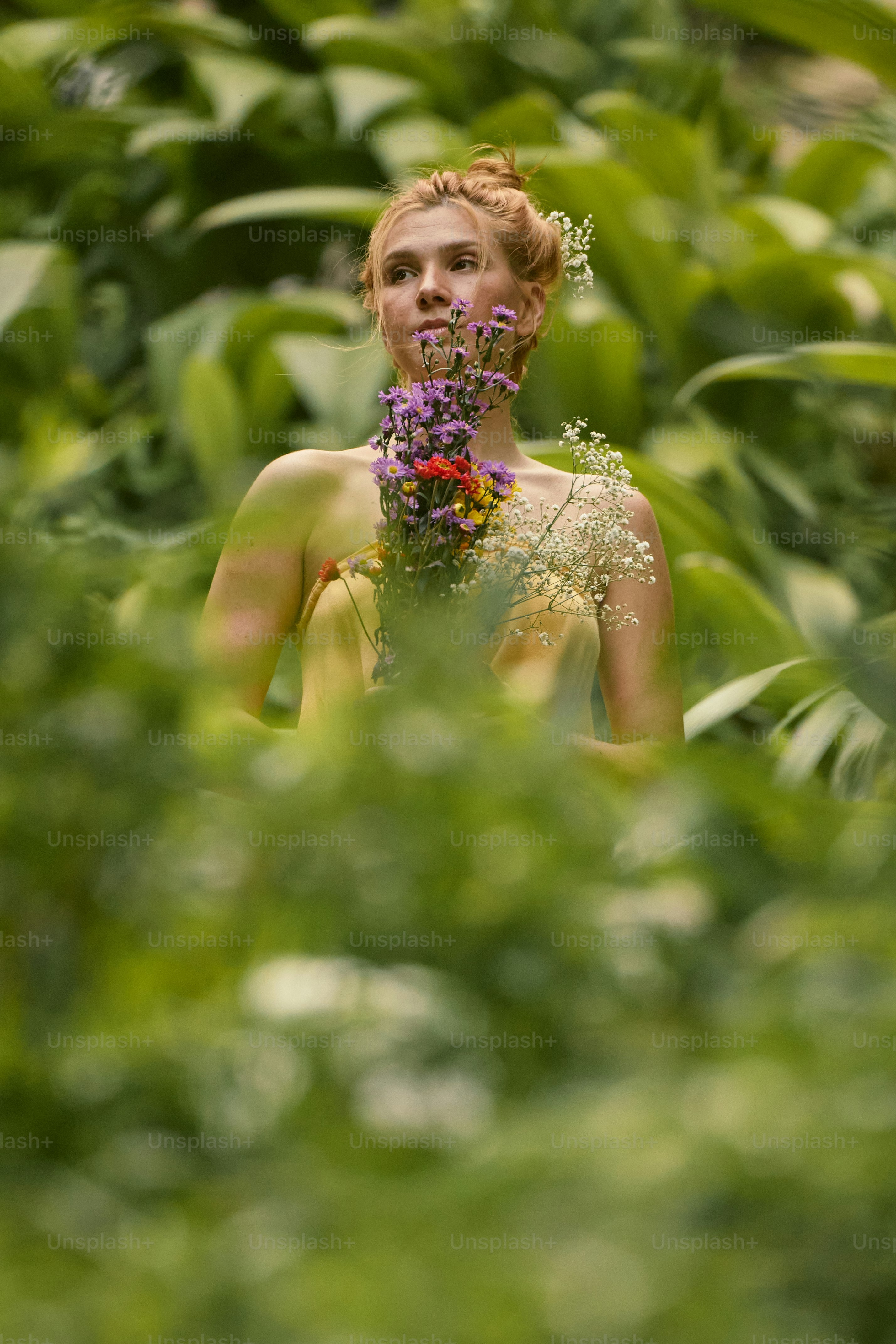 A woman with her eyes closed and a bouquet of flowers in front of her ...