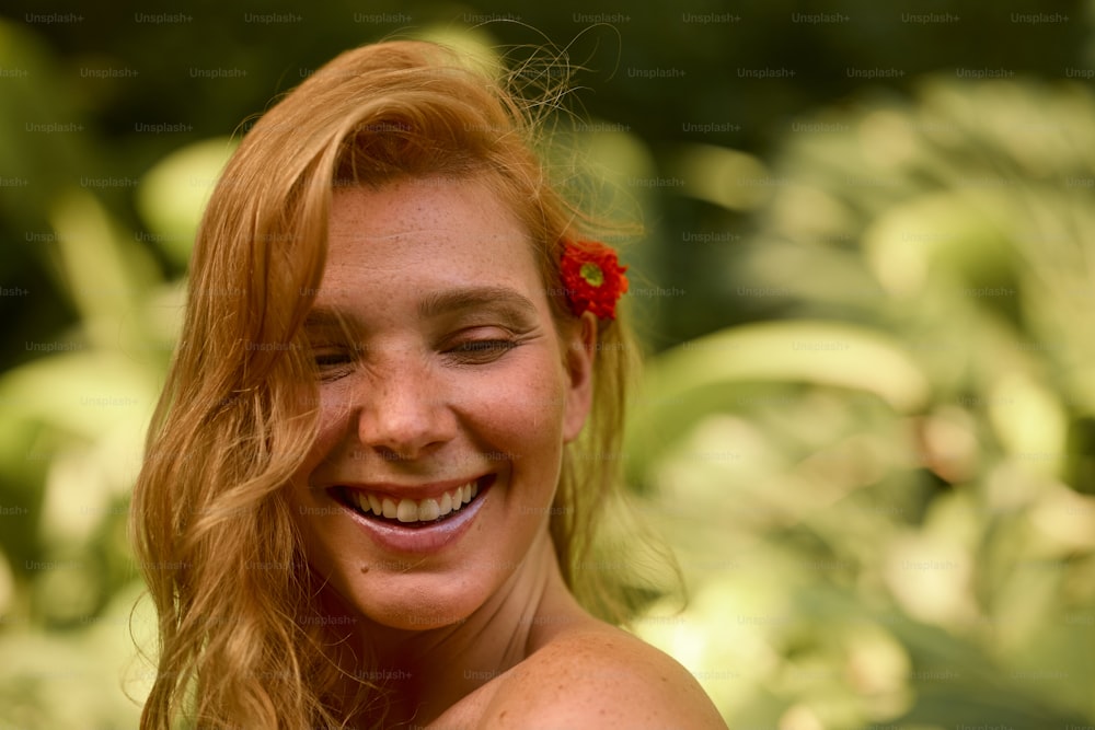 a woman with a red flower in her hair