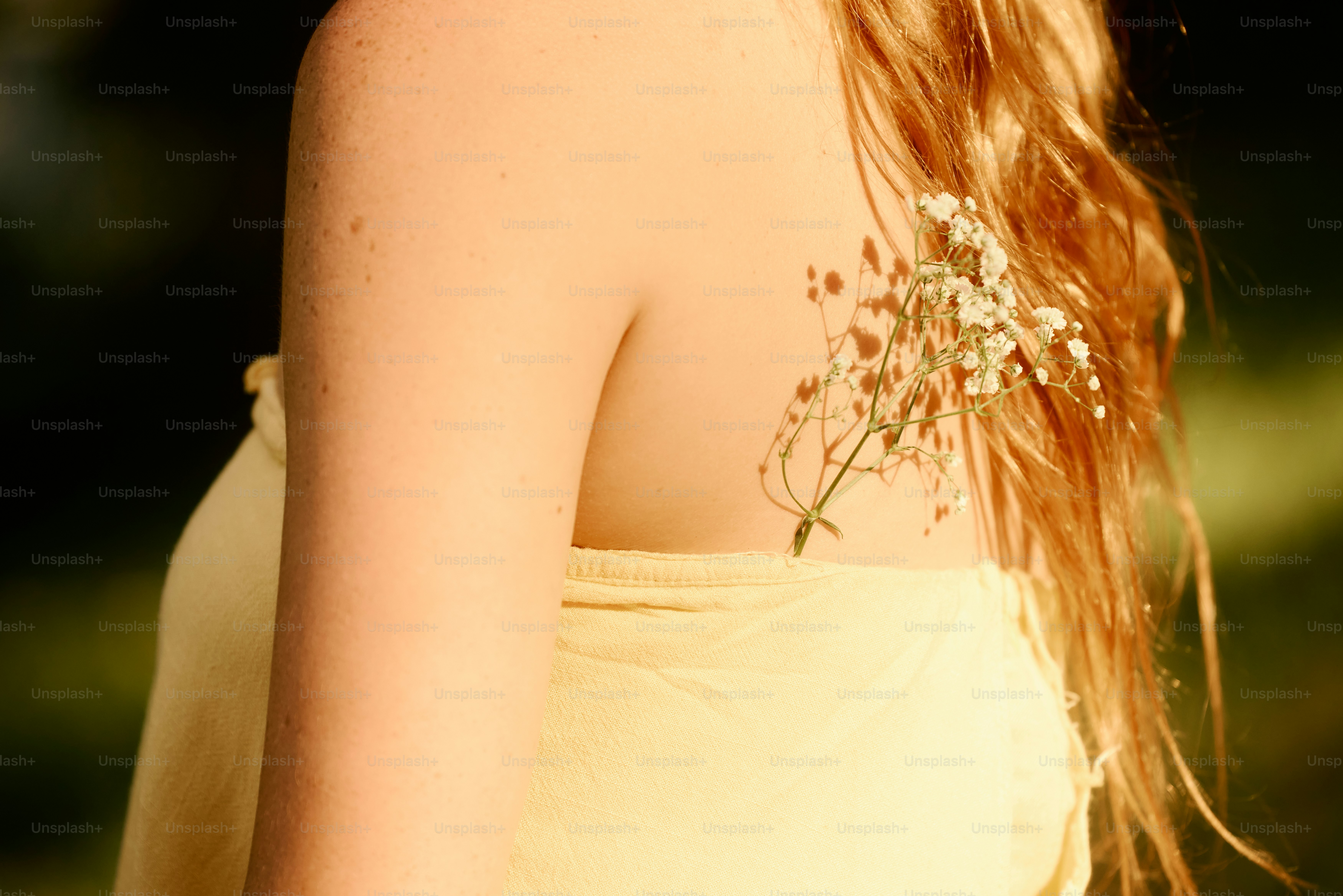 A close up of a woman with flowers in her hair photo – Flower Image on ...