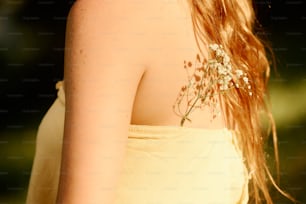 a close up of a woman with flowers in her hair