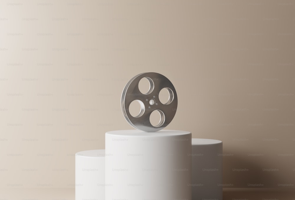 a film projector sitting on top of a white pedestal