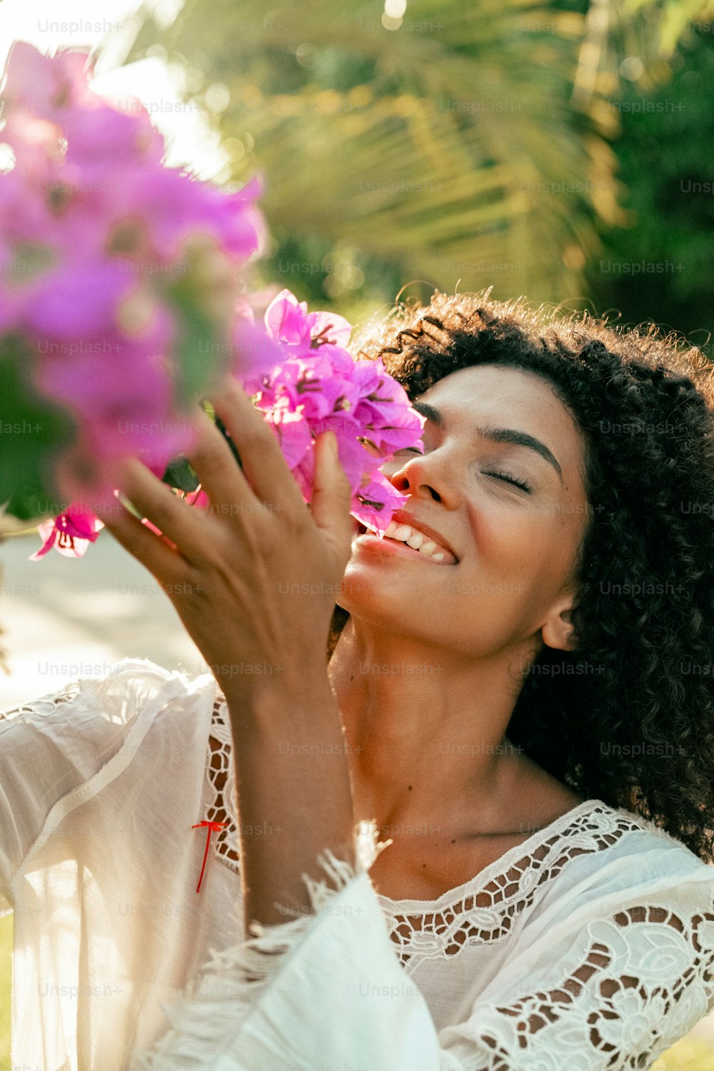 a woman holding a bunch of flowers in her hands