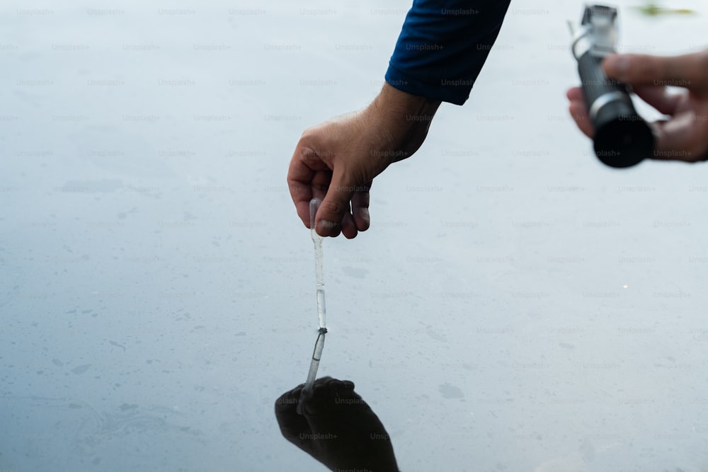 a person holding an object in the water