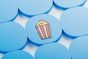 a popcorn cup sitting on top of blue circles