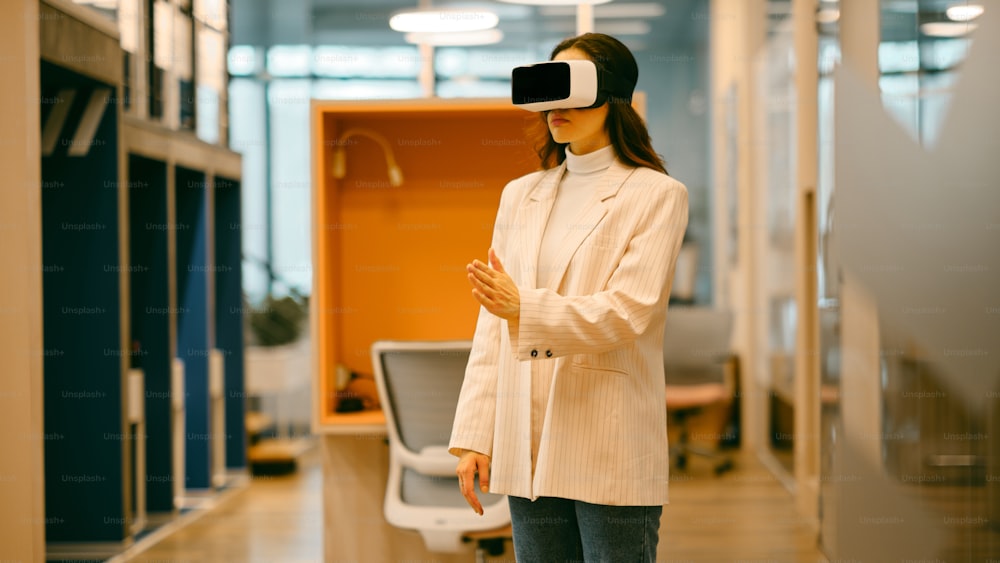 a woman standing in a room with a virtual headset