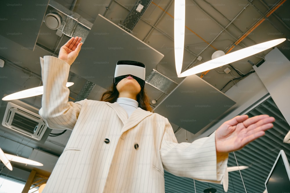 a woman in a suit and blindfold standing in a room