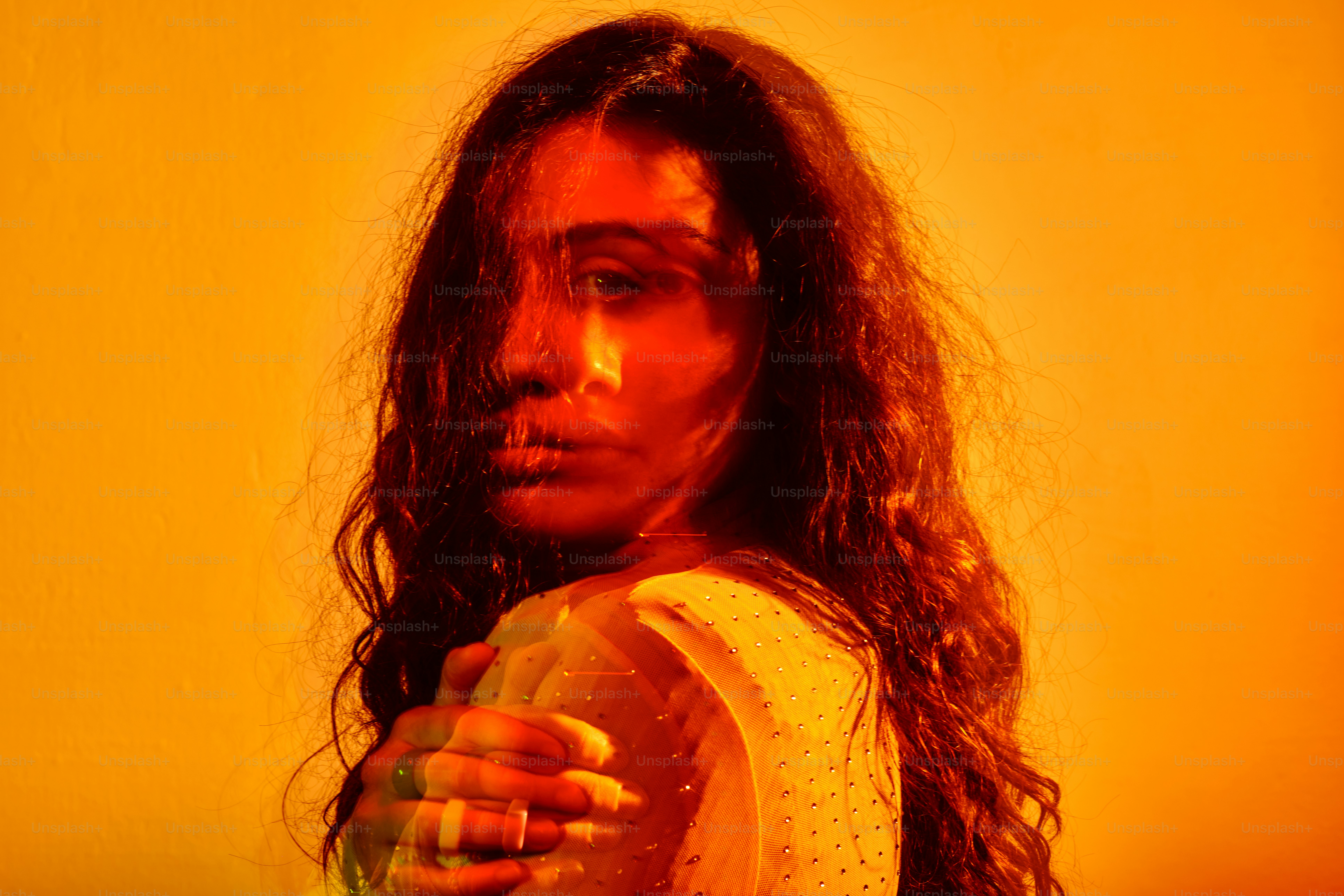 A woman with long hair standing in a red room photo – Abstract Image on ...