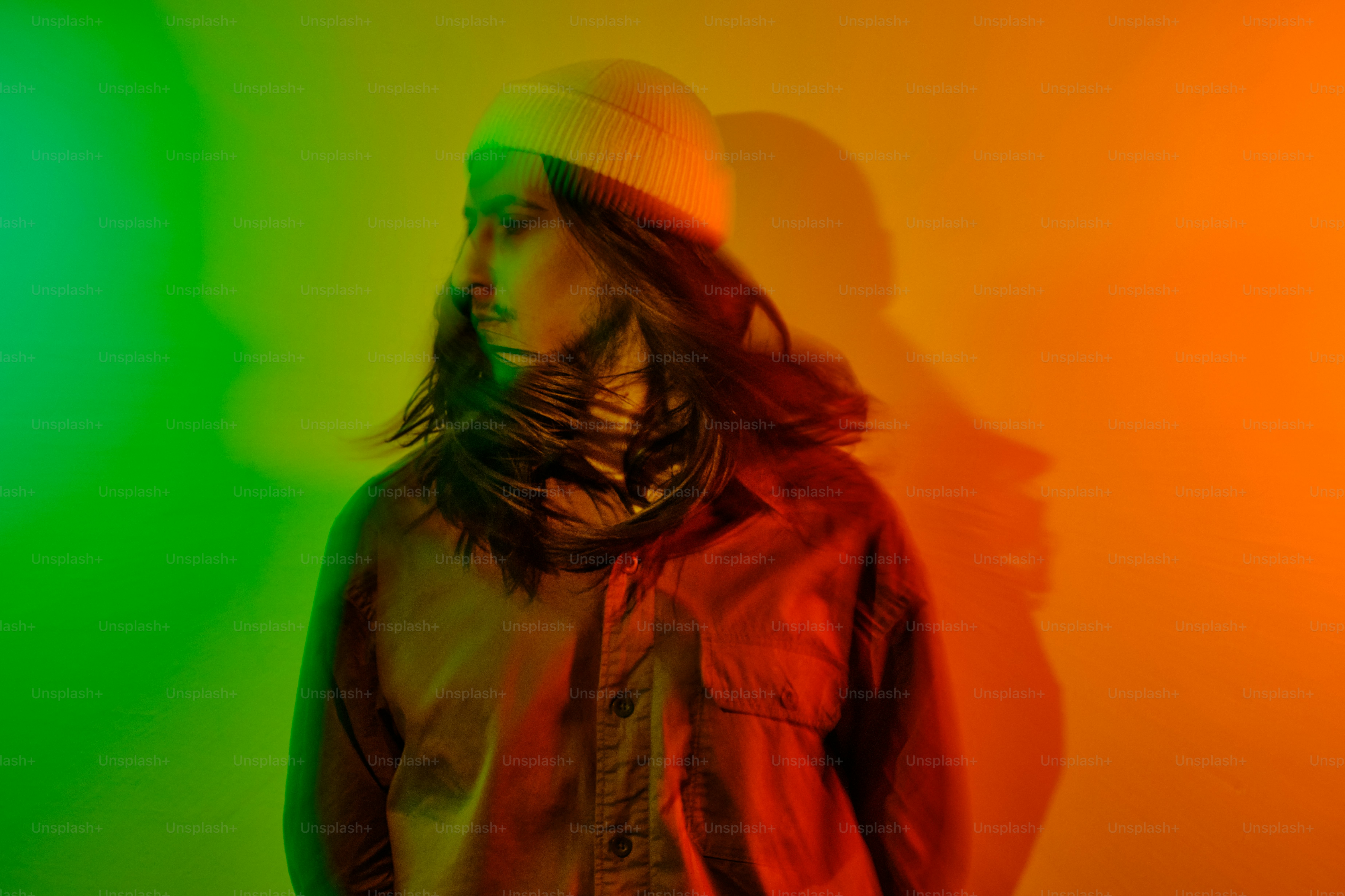 a man with long hair wearing a hat