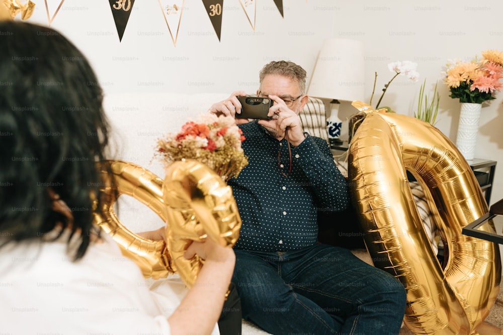 a man taking a picture of a woman holding a camera