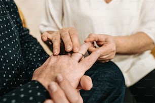 an older woman holding the hand of a younger woman