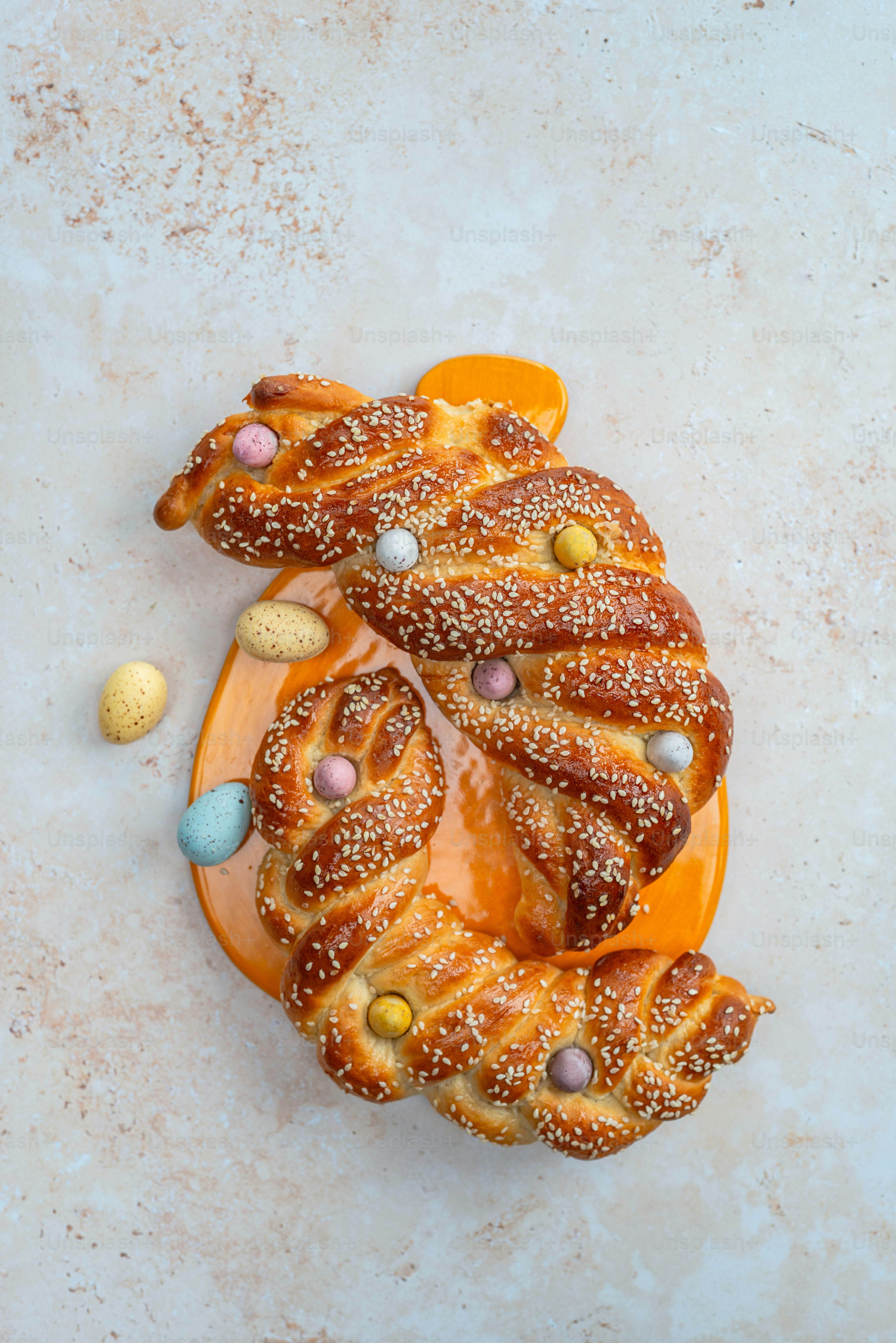 a pretzel is sitting on a plate with easter eggs