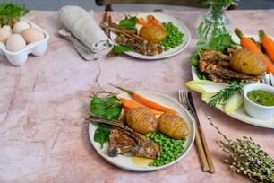 a table topped with plates of food and vegetables