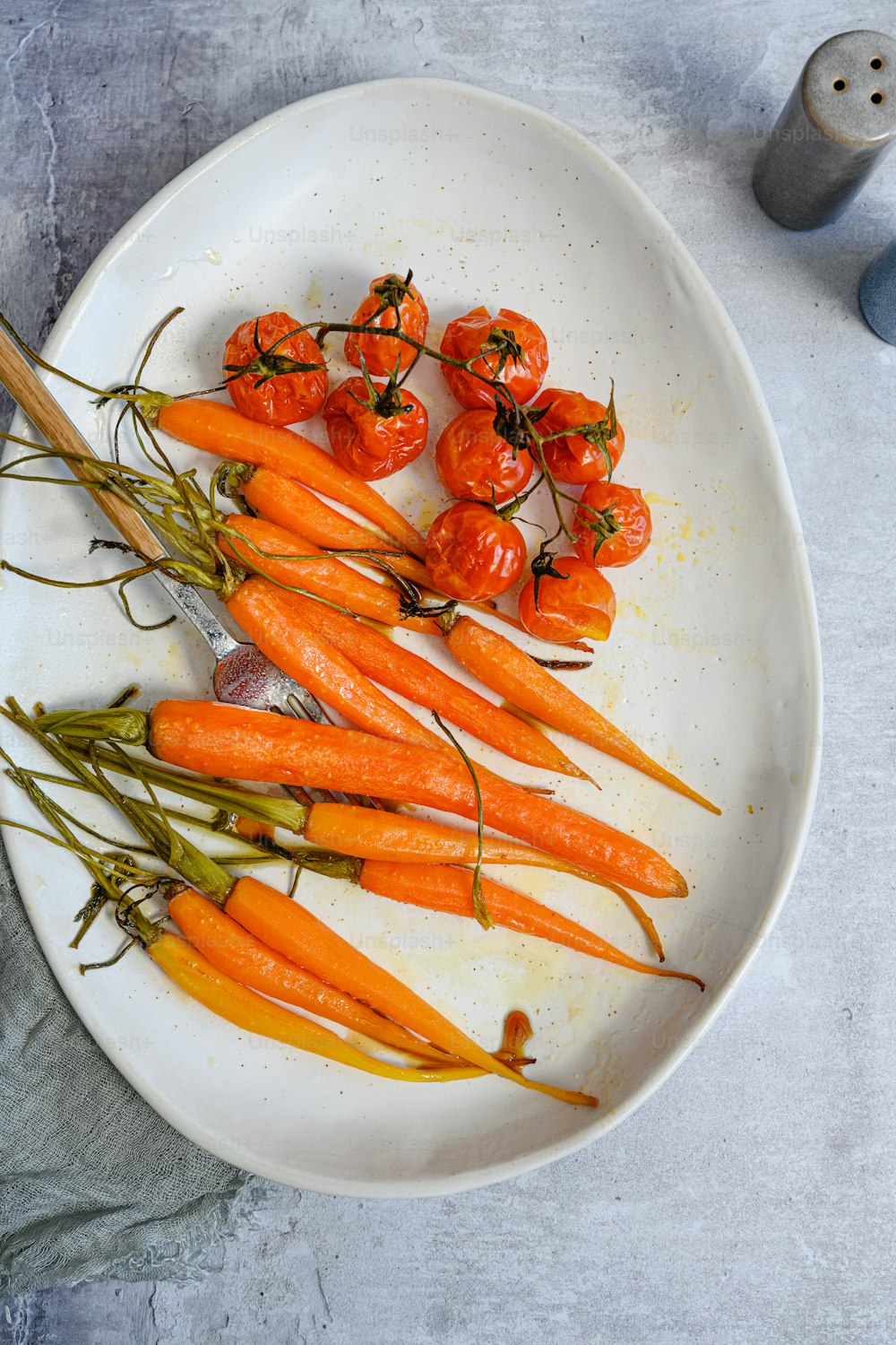 a white plate topped with lots of carrots
