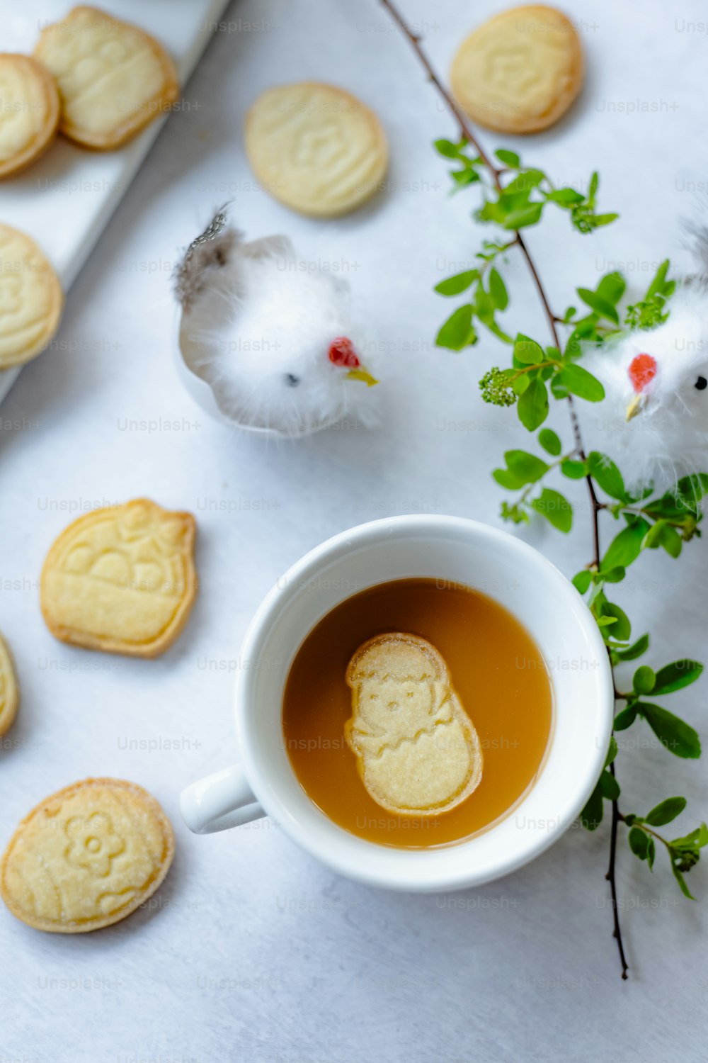 a cup of tea next to some cookies
