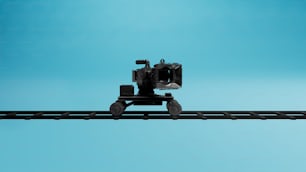 a camera sitting on top of a train track