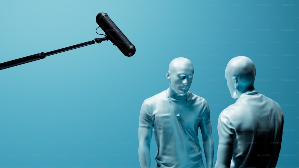 a microphone and two mannequins standing in front of a blue background