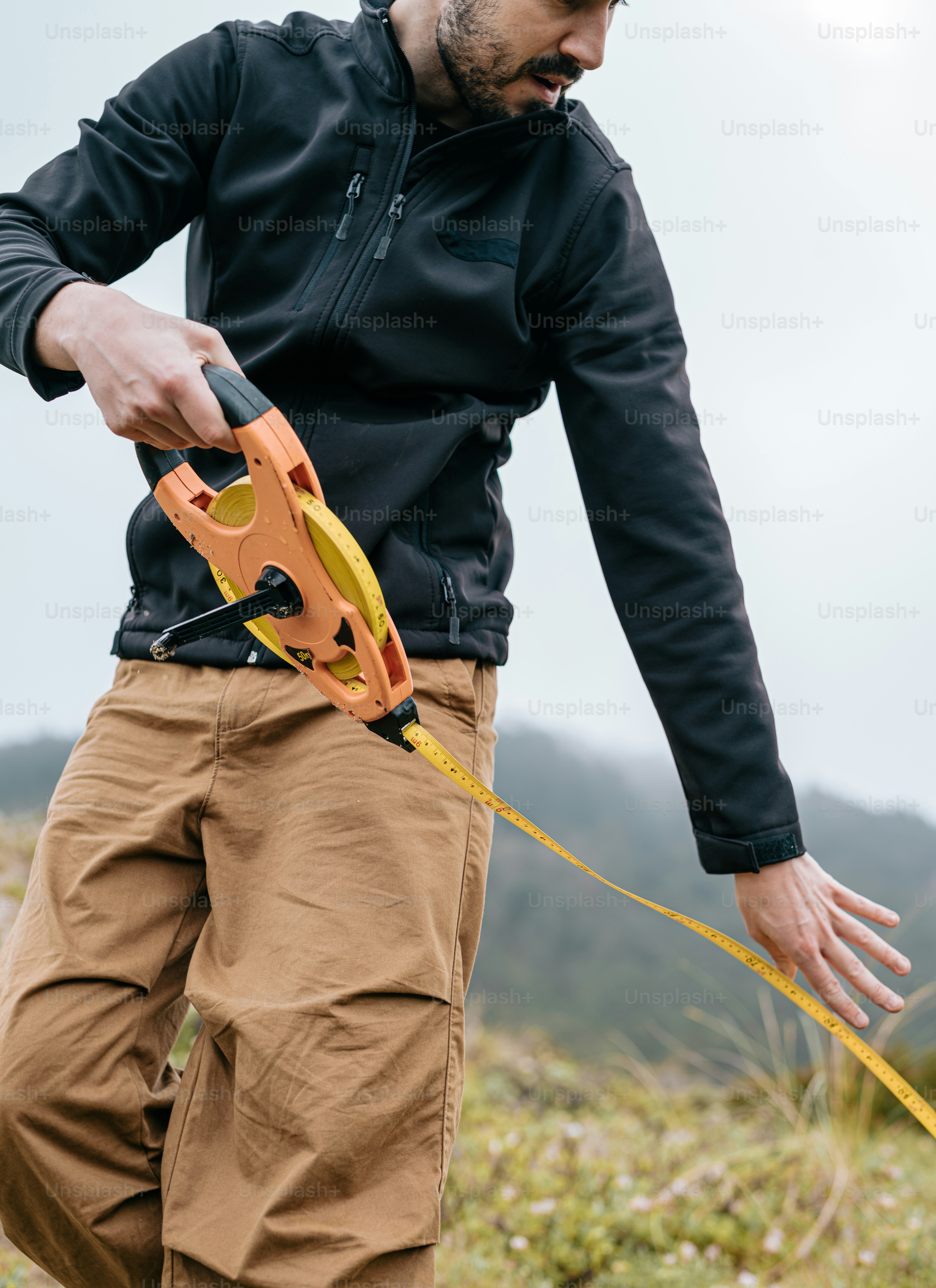 A person measuring a tree with a tape measure photo – Plant Image on ...