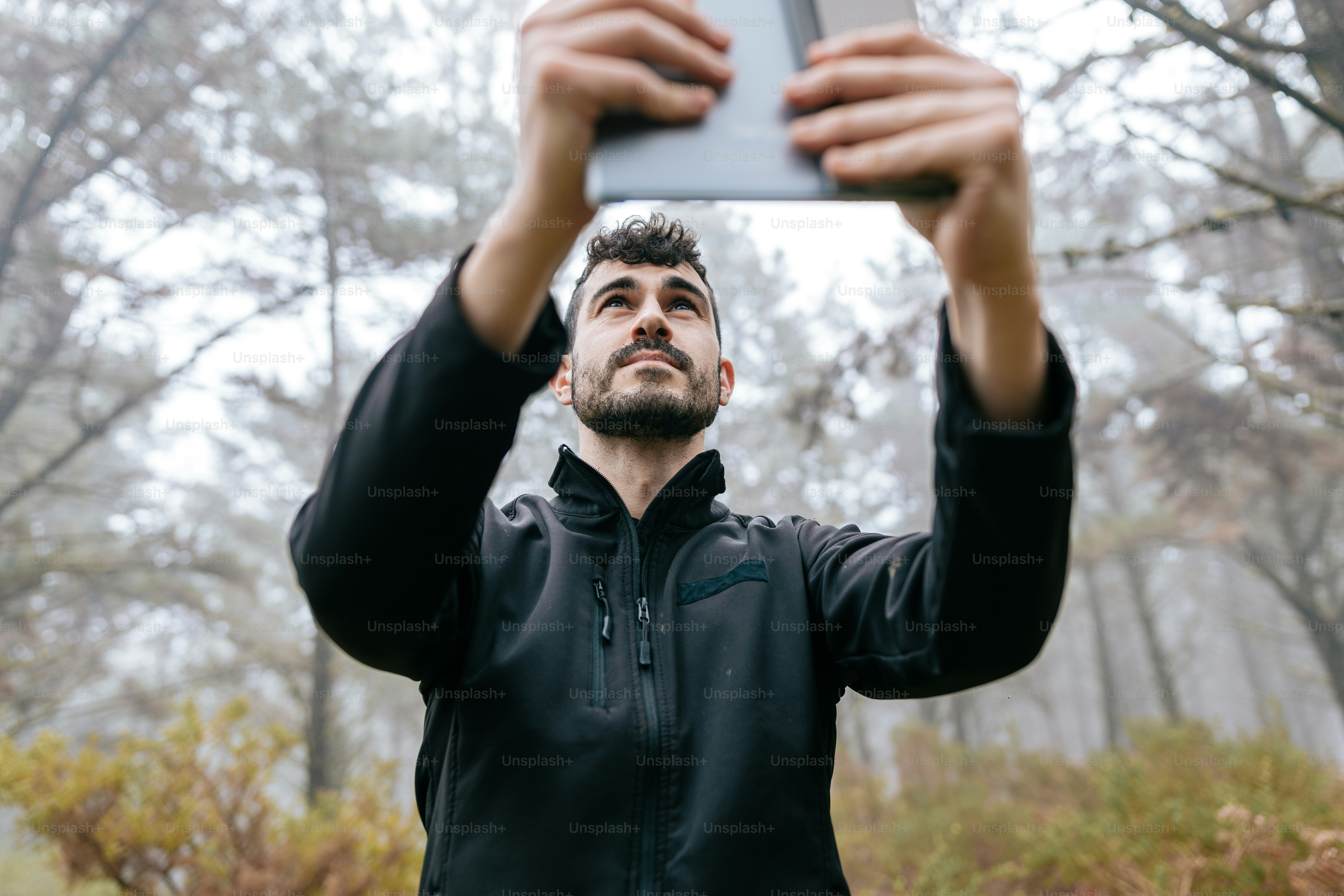 a man taking a picture with his cell phone