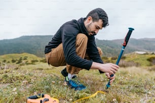 a man kneeling down in the grass with a baseball bat