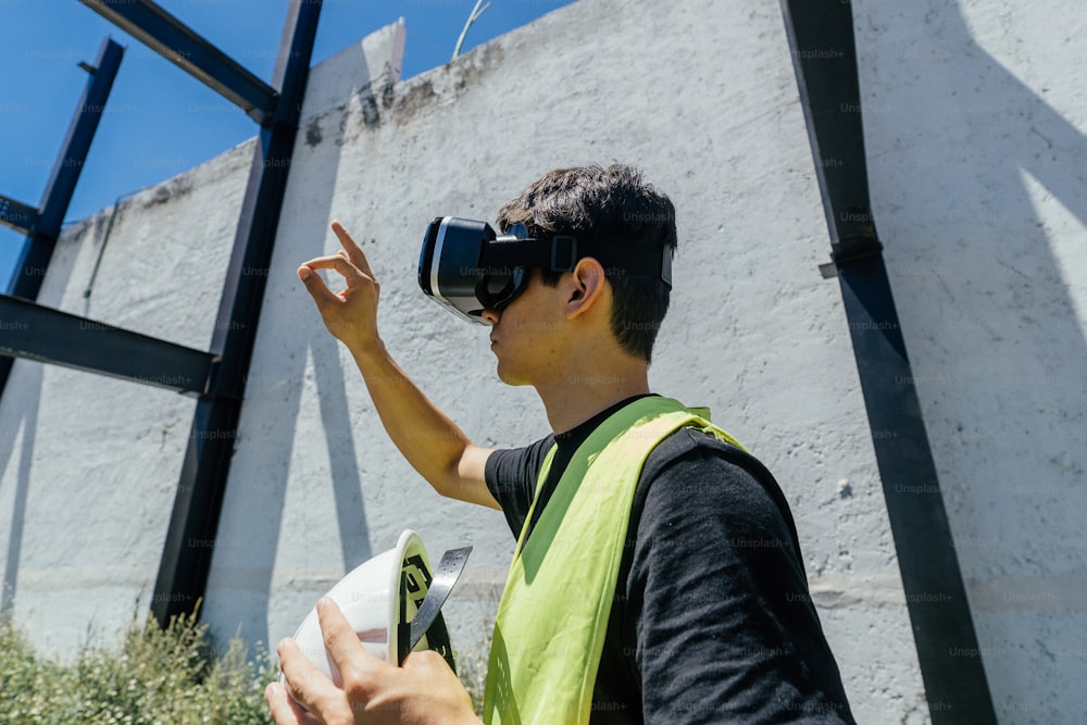 a man in a yellow vest using a pair of virtual glasses