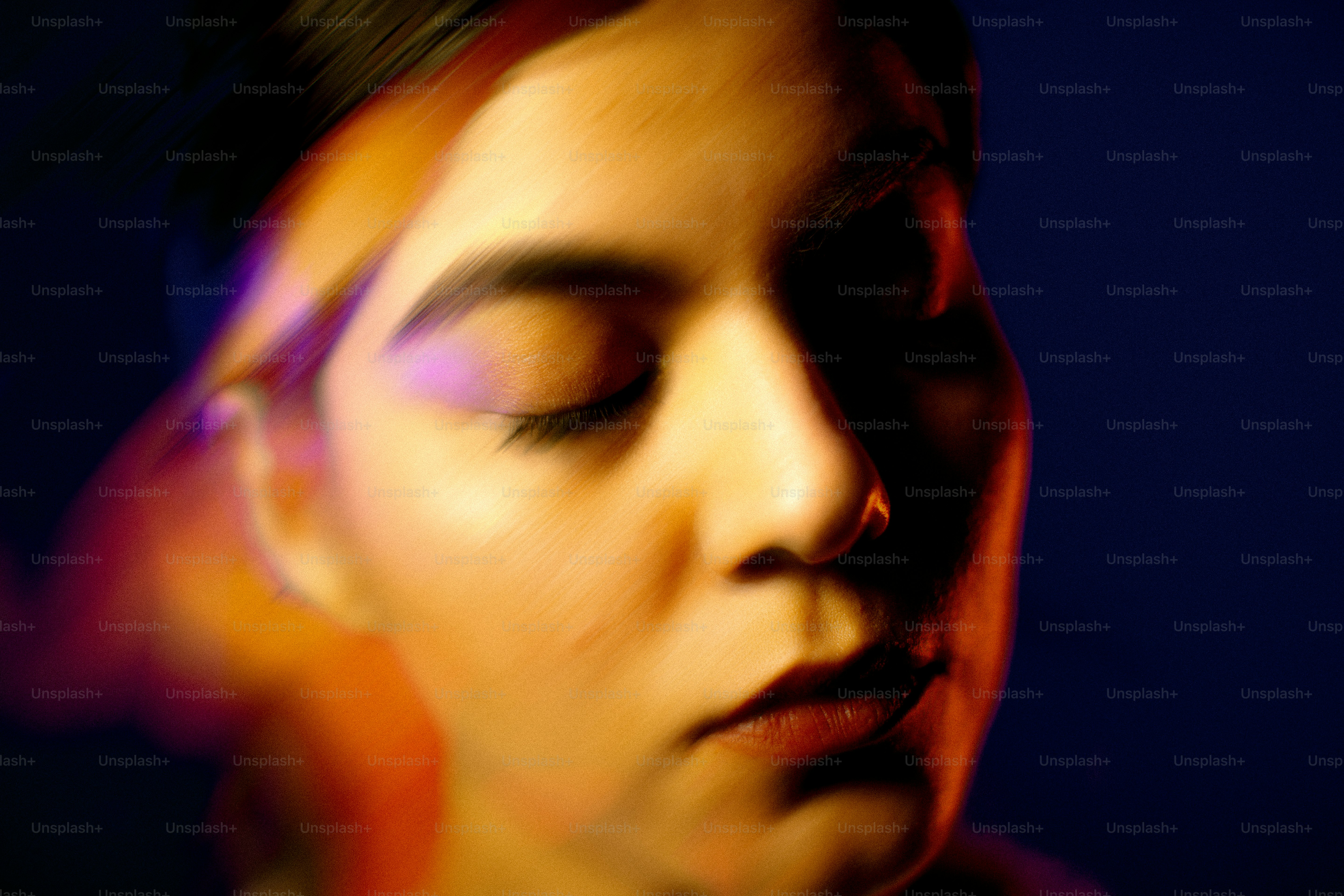 a blurry photo of a woman with her eyes closed