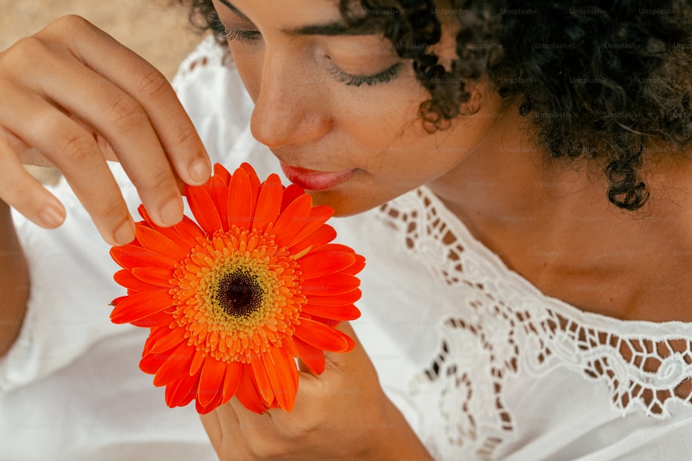 a close up of a person holding a flower