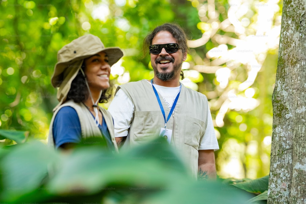 a man and a woman standing next to a tree