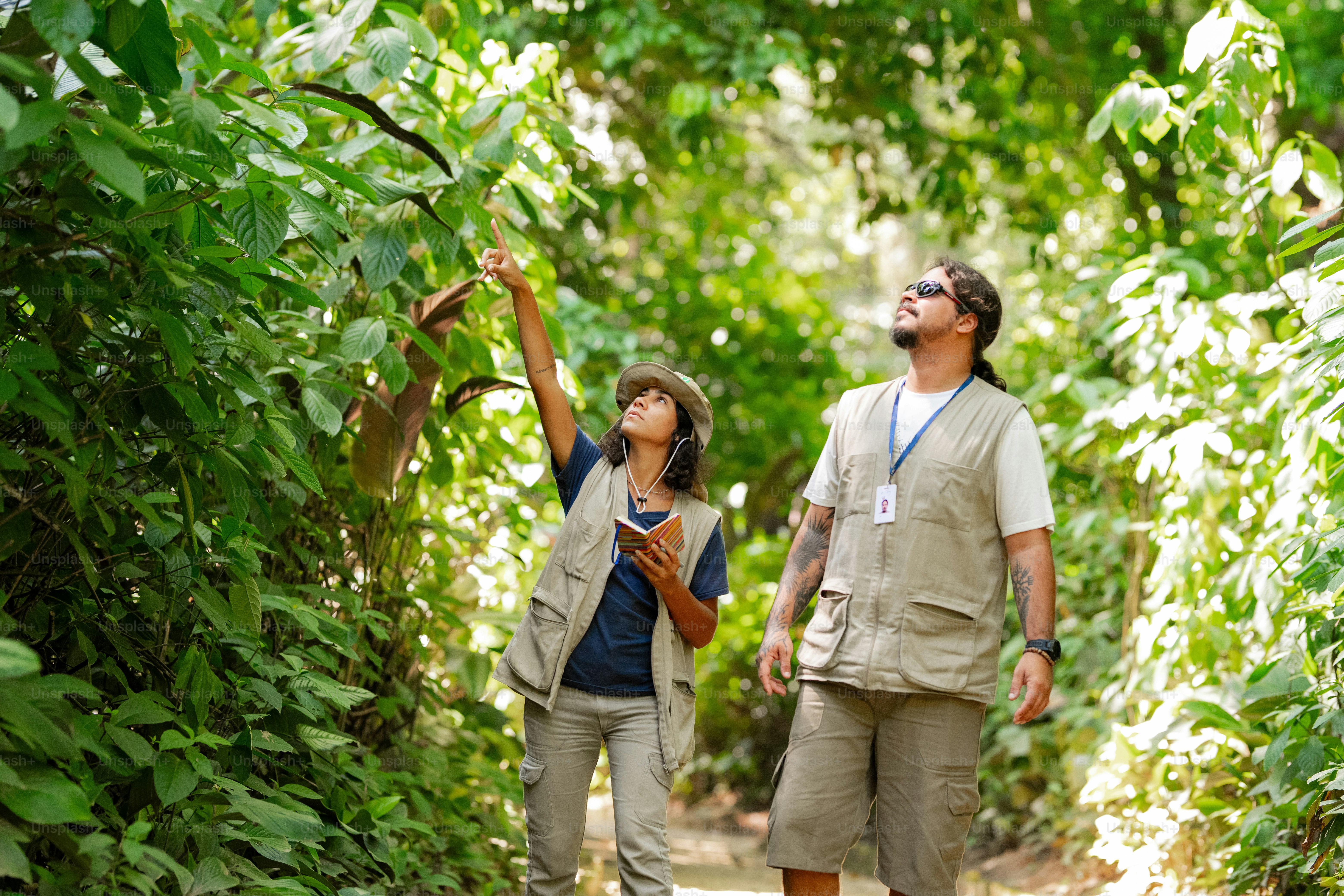 a man and a woman walking through a forest