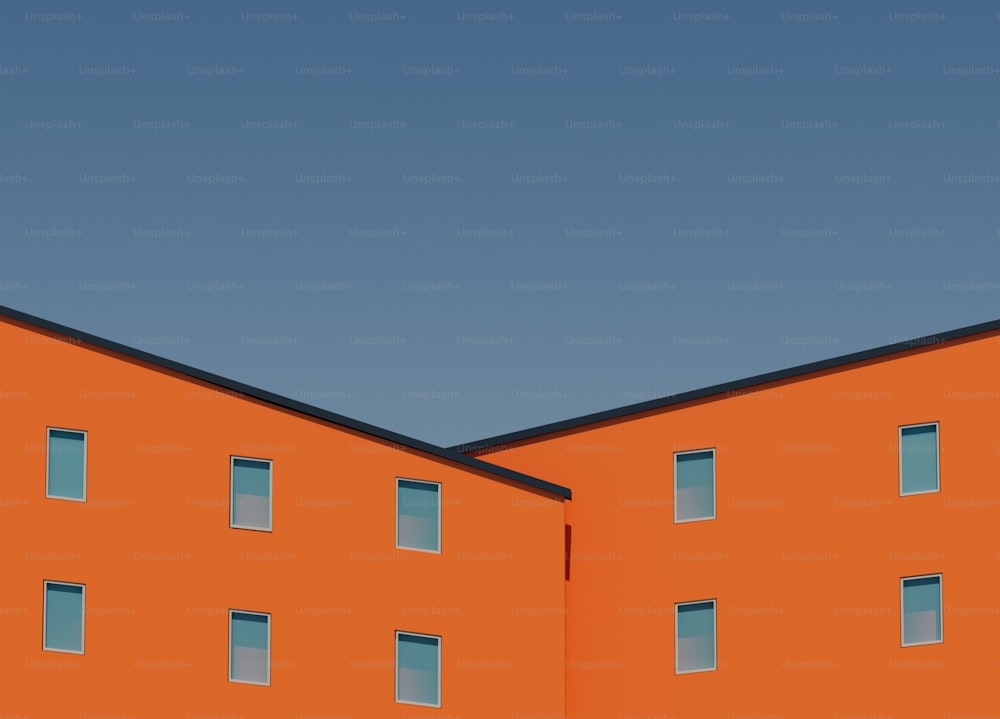 a large orange building with windows and a clock