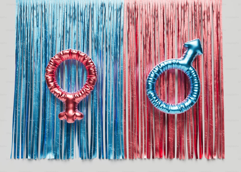 a red, blue, and pink wall hanging with a metal ring