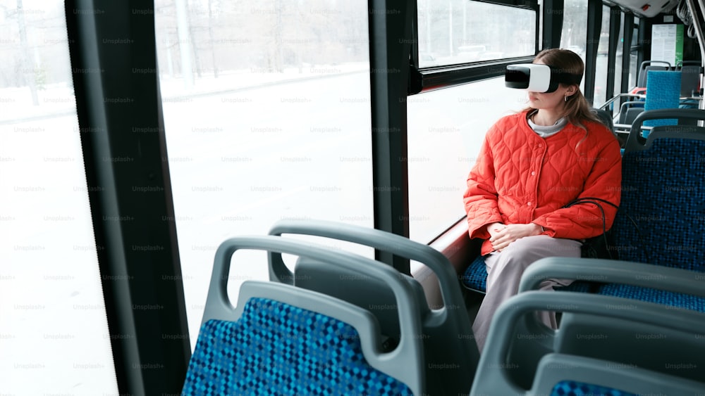 a woman sitting on a bus wearing a blindfold