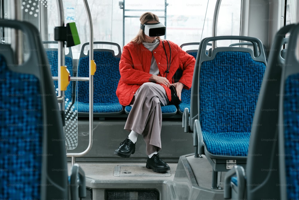 a woman wearing a blindfold sitting on a bus