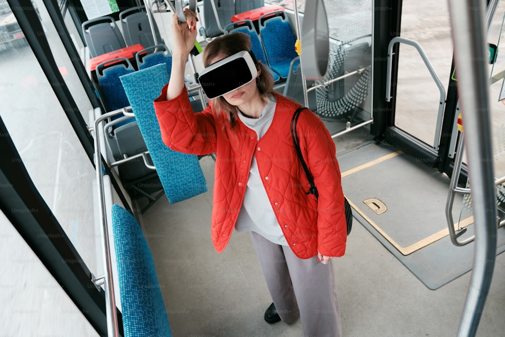 a woman wearing a red jacket and blindfolded jacket on a bus