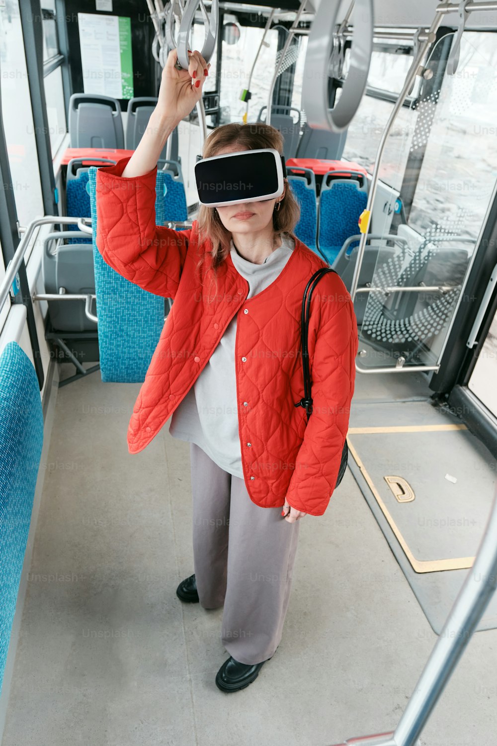 a woman on a bus wearing a virtual headset