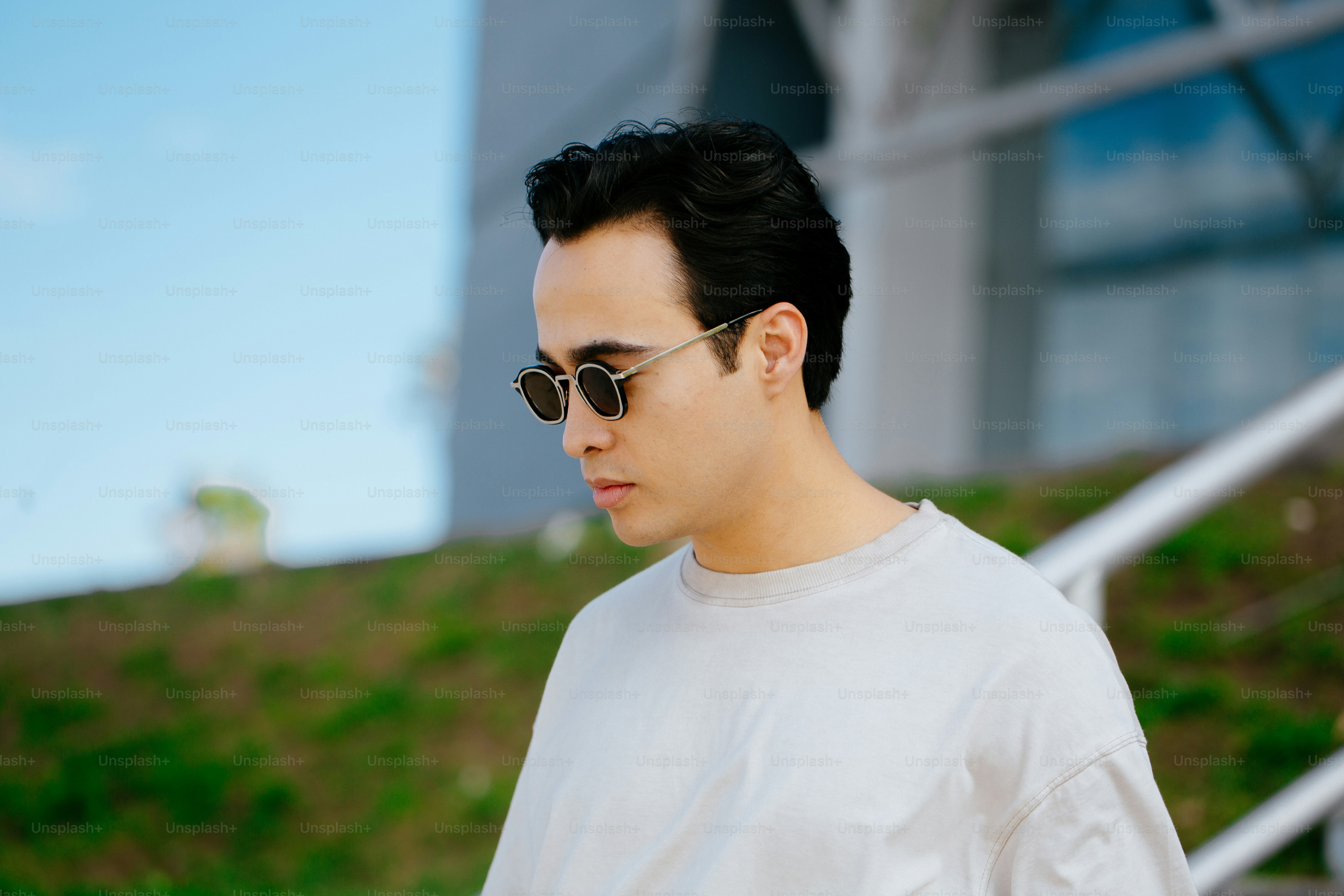 a man in sunglasses looking at his cell phone