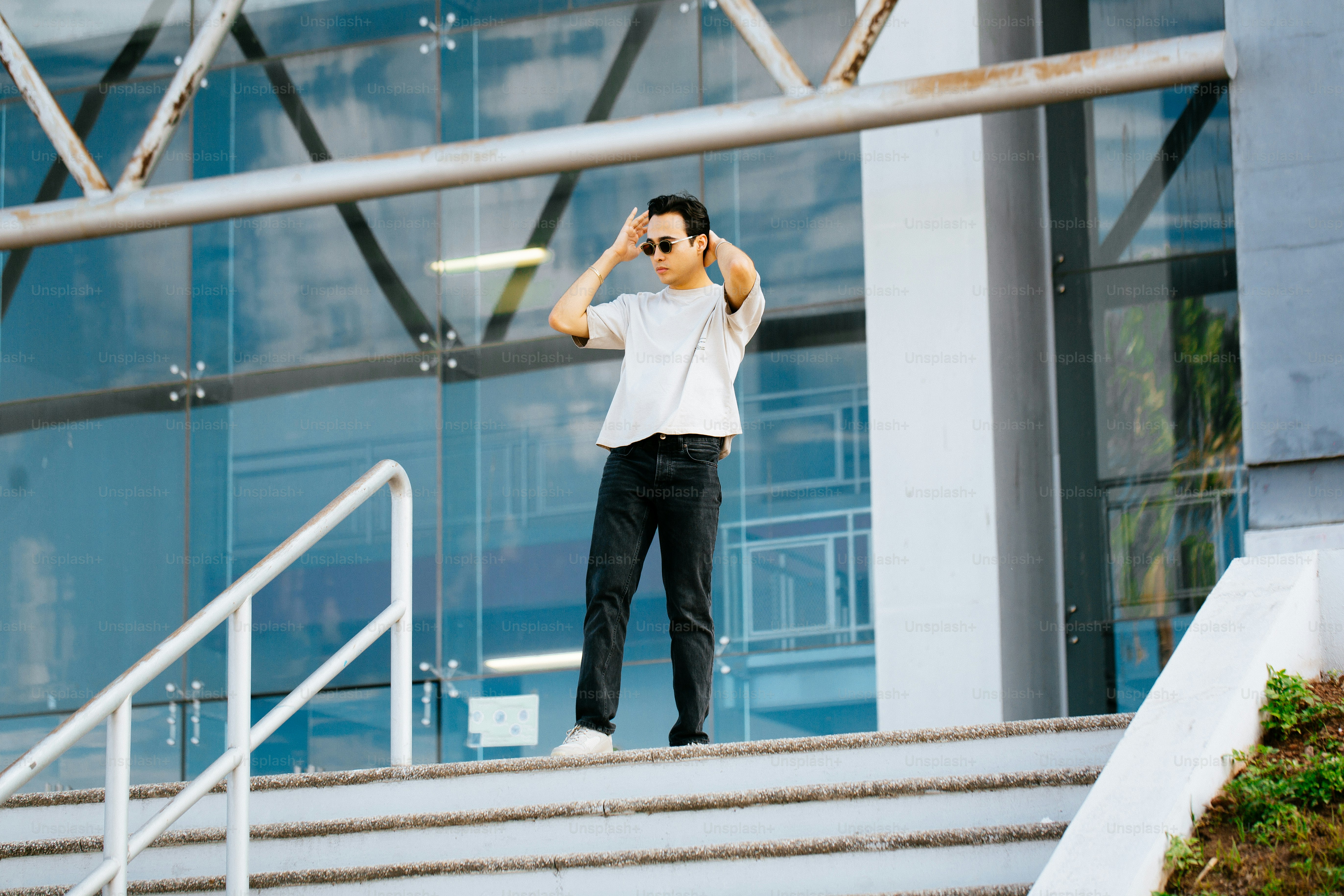 a man standing on a set of stairs talking on a cell phone
