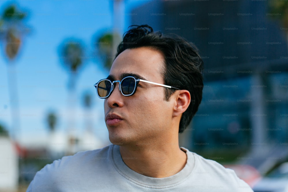 a man wearing sunglasses looking off into the distance