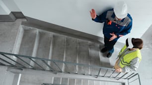 a man and a woman standing on a stair case