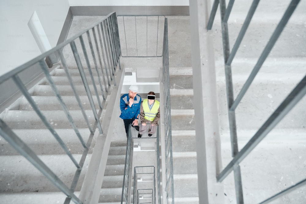 a couple of people that are standing on some stairs