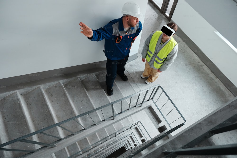 two men in safety vests standing next to each other