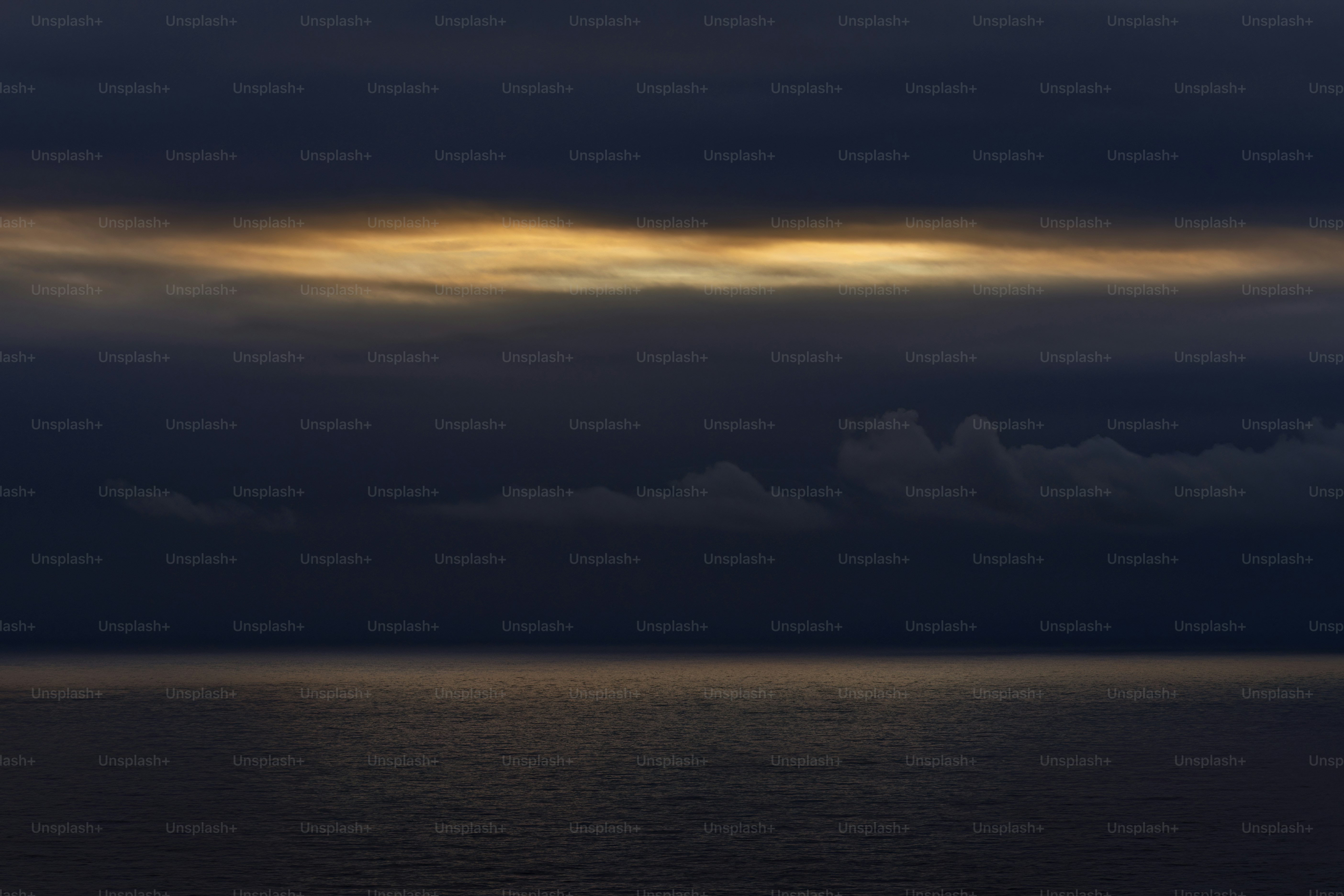 a large body of water under a cloudy sky