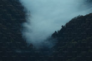 a mountain covered in fog and low lying clouds