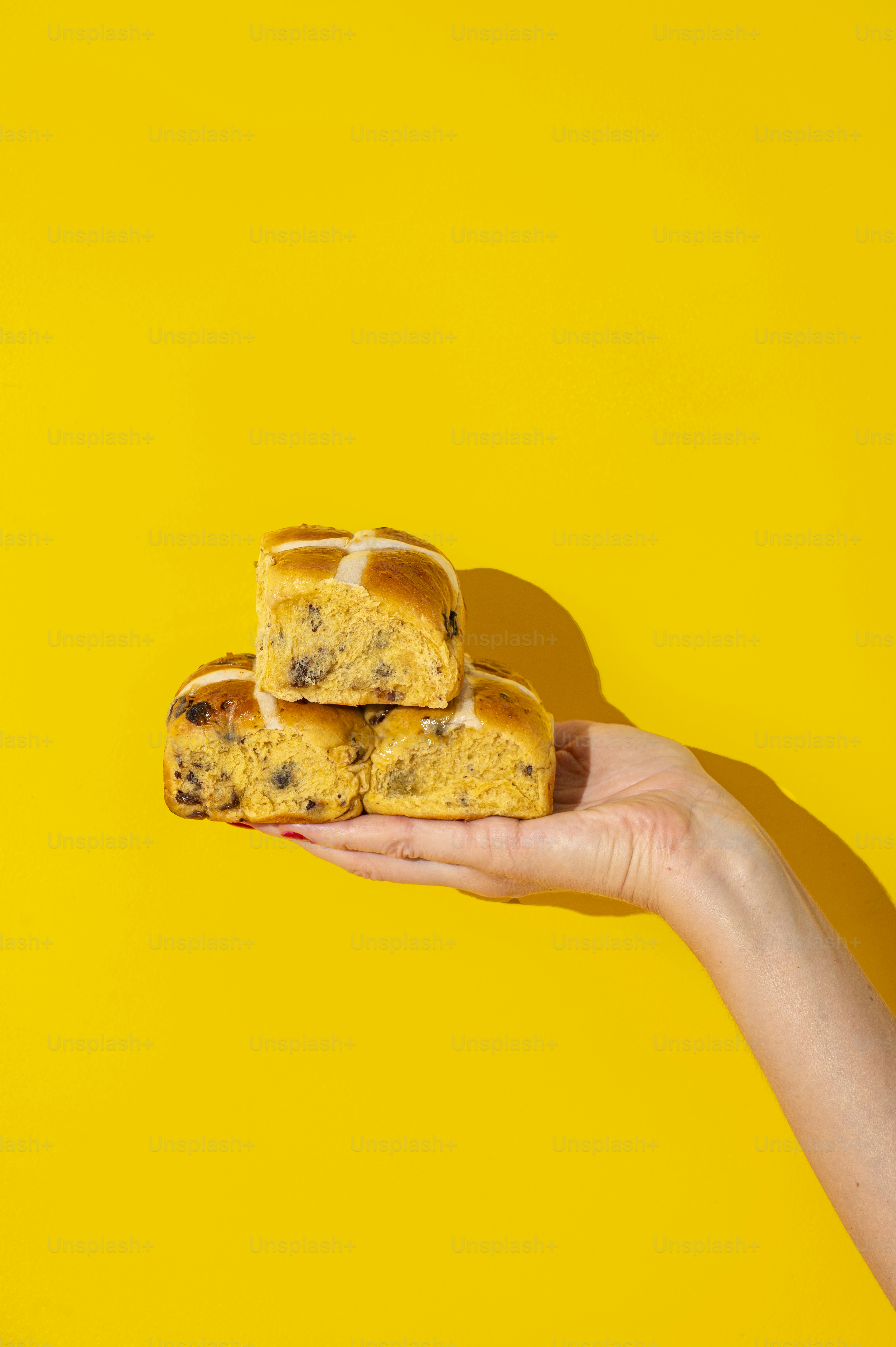 a person holding a piece of bread in their hand