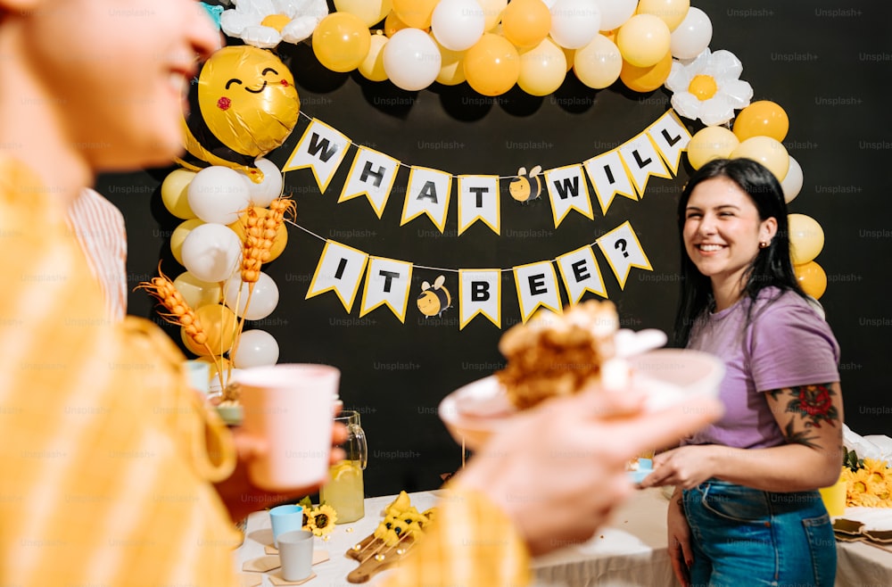 a woman holding a plate of food at a party