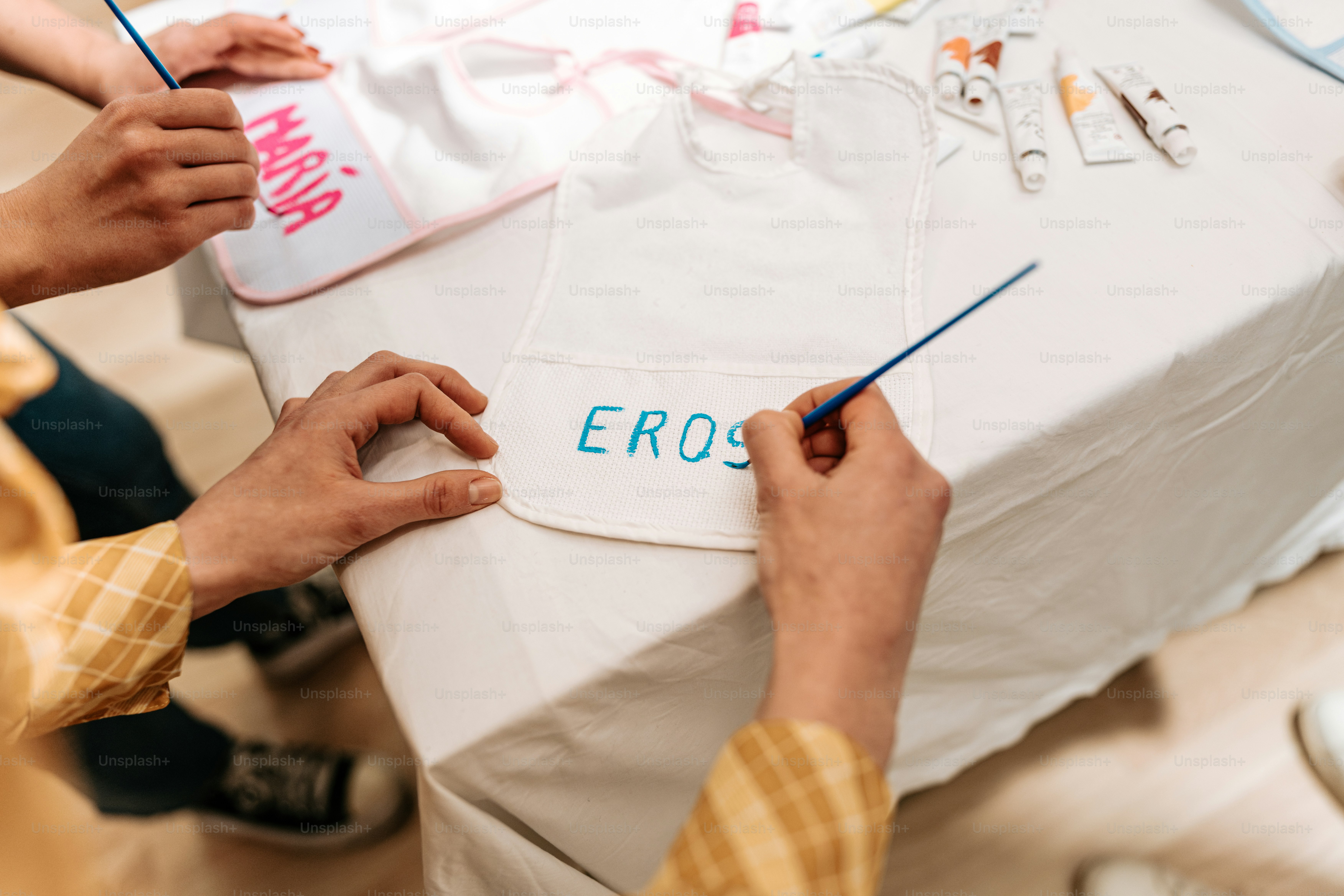 a group of people doing crafts on a table
