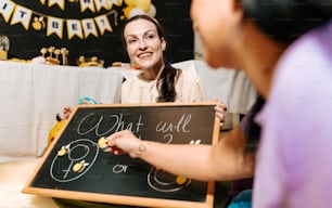a woman holding a chalk board with writing on it
