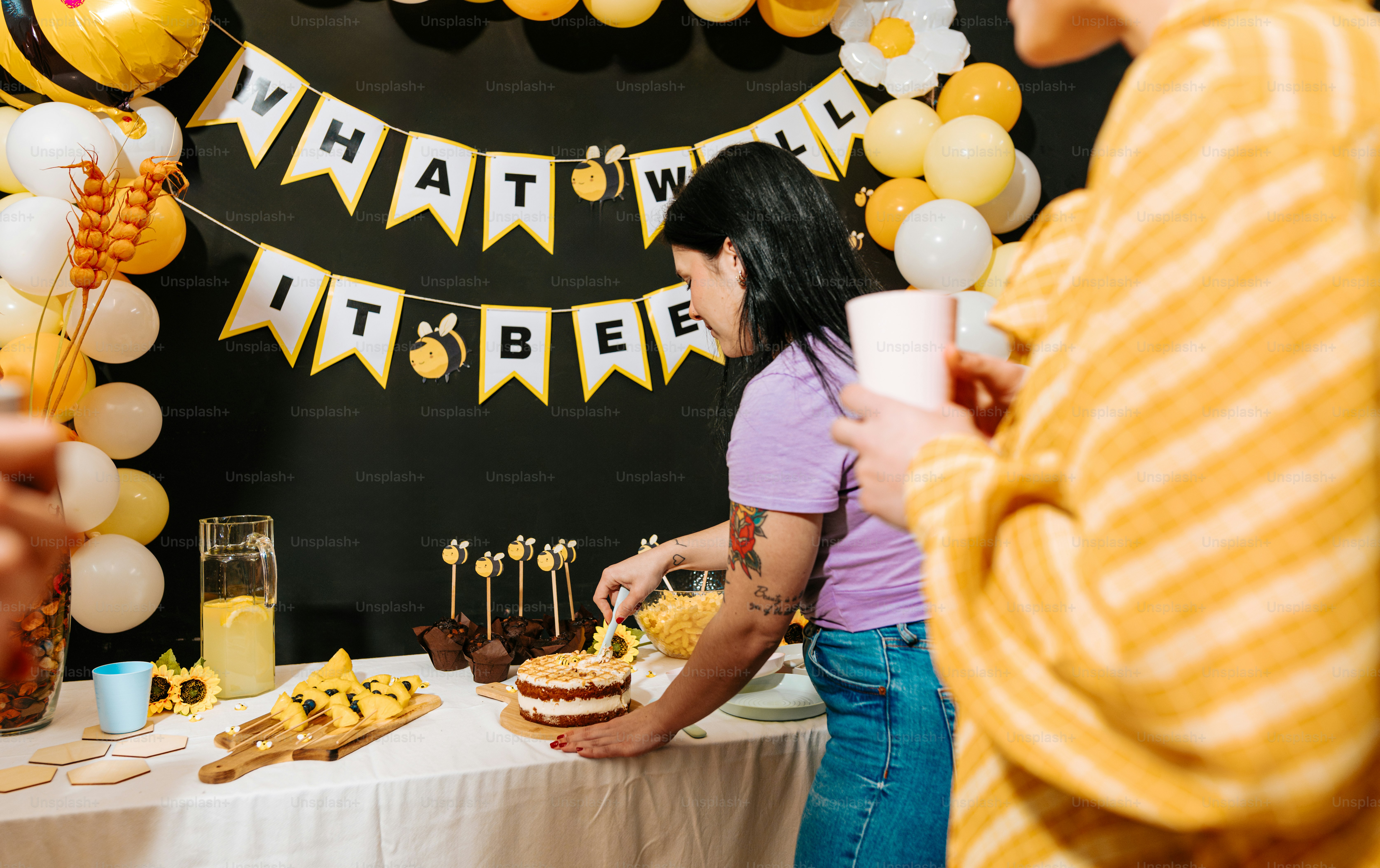 A group of people standing around a table with a cake photo – Banner ...