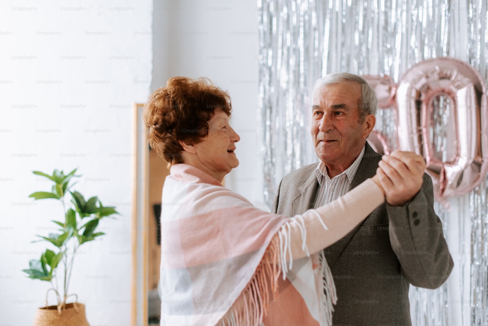 a man and a woman holding up a pink balloon